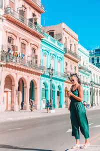 Full length portrait of woman standing in city