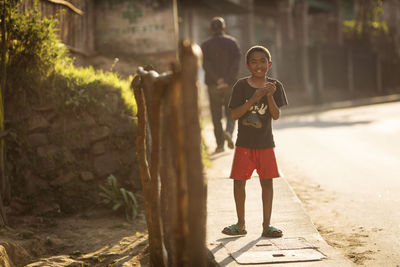 Full length portrait of boy standing outdoors