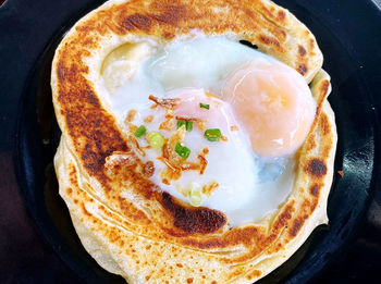 Roti canai with double boiled egg at centre of it 