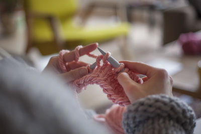 Cropped image of hands knitting wool