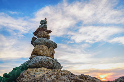 Low angle view of stack of rocks against sky