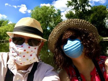 Portrait of man and a woman wearing masks while outdoors
