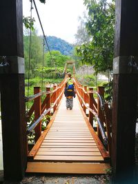 Rear view of man on footbridge