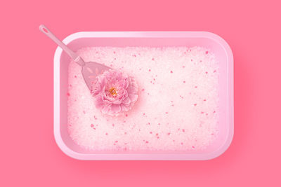 High angle view of pink drink on red surface