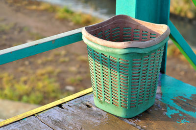 Small green trash can made of plastic