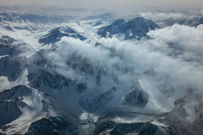 Scenic view of snow covered mountains against sky