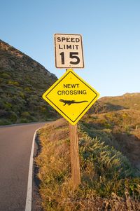 Information sign on road against clear sky