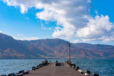 Lake towada lakeside pier, clear sky with blue water and white cloud in sunny day. aomori, japan