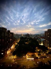 High angle view of illuminated city buildings against sky