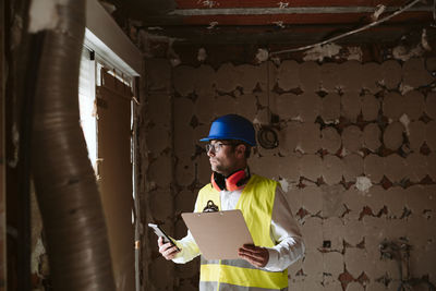 Foreman or architect working on blueprints on construction site. home improvement