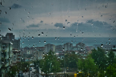 Full frame shot of wet glass window in rainy season