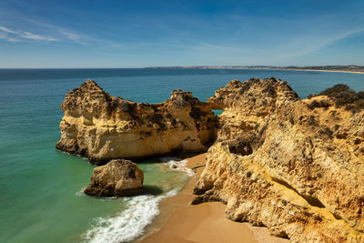 Panoramic view of rock formation in sea against sky