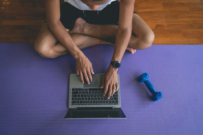 Low section of woman doing yoga on table