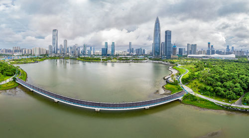 Panoramic view of river and buildings in city against sky