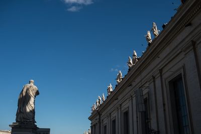 Low angle view of statue against blue sky