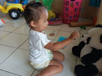 High angle view of baby boy playing with toy at home