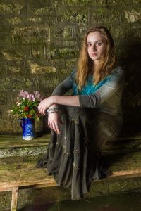 Portrait of beautiful woman sitting on floor