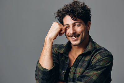 Portrait of young man against white background