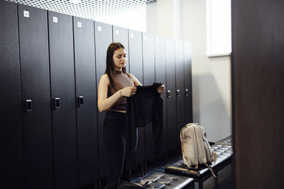 Rear view of young woman using phone