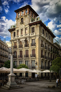 Buildings against cloudy sky