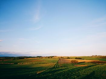 Scenic view of field against cloudy sky