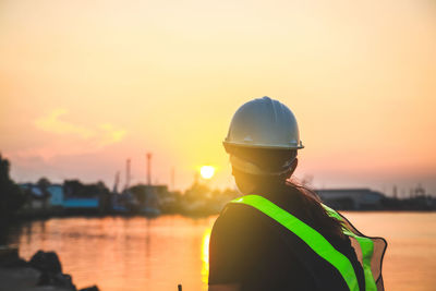 Rear view portrait of man against sky during sunset