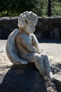 Close-up of angel statue on rock