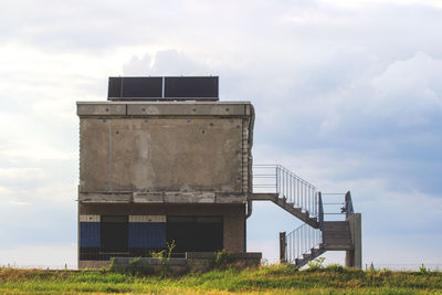 Built structure on field against sky