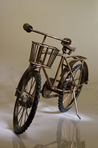 Close-up of bicycle against gray background