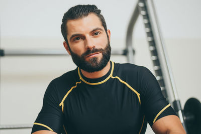 Portrait of beautiful sweaty man after a training gym session.  sporty boy at the end of the workout