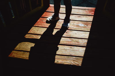 Low section of woman walking on footpath