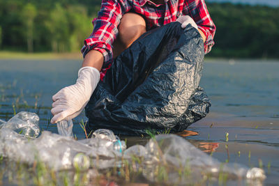 Low section of man at lakeshore