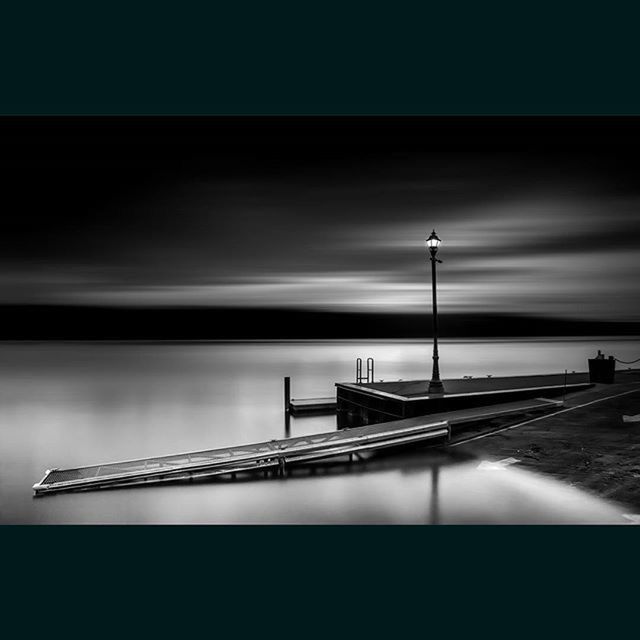 water, sea, horizon over water, sky, transfer print, auto post production filter, pier, tranquil scene, scenics, tranquility, nature, beauty in nature, beach, railing, dusk, built structure, shore, outdoors, idyllic, illuminated