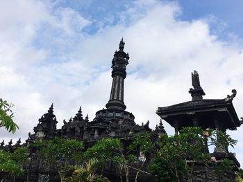 Low angle view of temple against cloudy sky
