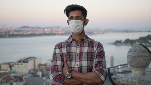 Portrait of young man standing in city