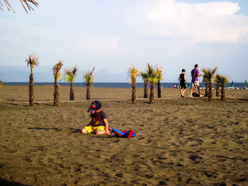 Boy playing on sand at beach