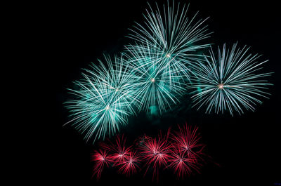 Low angle view of firework display against sky at night