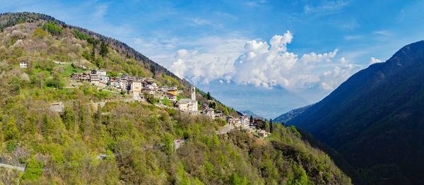 Panoramic view of townscape and mountains against sky