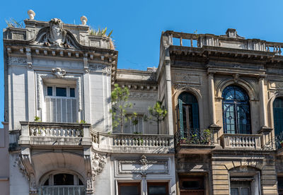 Low angle view of building against clear blue sky