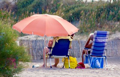 People sitting on chair at beach