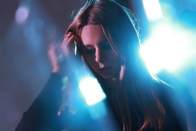 Portrait of young woman looking at camera