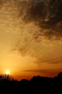 Silhouette of mountain against dramatic sky