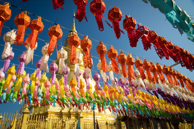 Low angle view of decorations hanging against sky