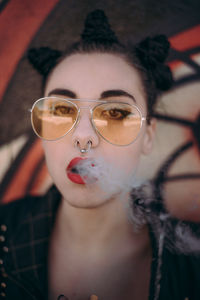 Close-up portrait of young woman in sunglasses