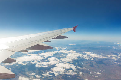 Aerial view of airplane flying in sky