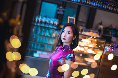 Beautiful young woman standing in store