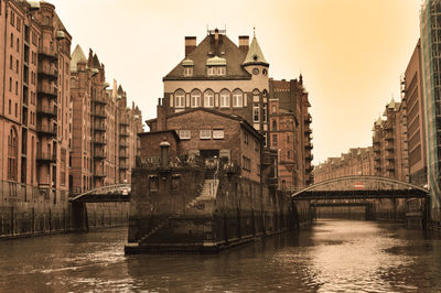 Bridges over river amidst buildings in city