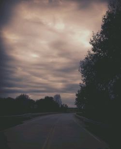 Road against cloudy sky at sunset