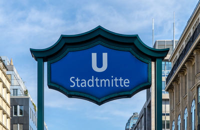 Low angle view of text of railroad station against sky