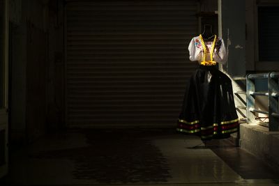 Rear view of people in traditional clothing at night